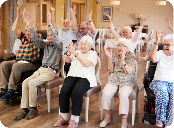 Residents cheering with their arms raised in a group session