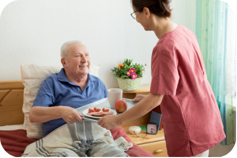 A caregiver bringing a resident breakfast