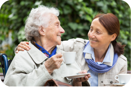 A resident and her daughter sharing a coffee
