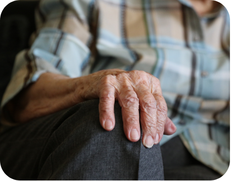 A resident's hand resting on his knee